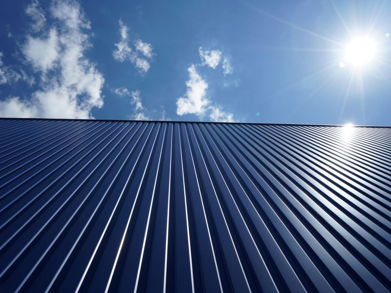 A low angle shot of a metal roof of a building on a sunny day