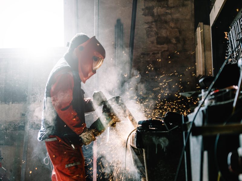 man-works-with-grinder-cutting-metal-2023-11-27-05-25-59-utc